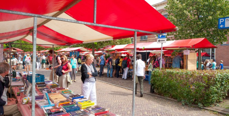 Shopping people at market stalls of vintage book fair