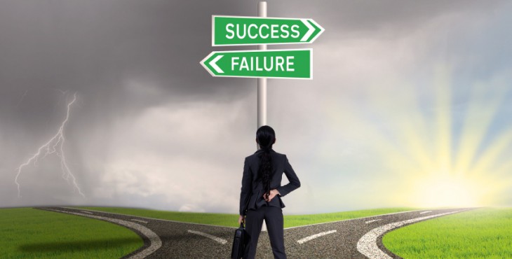 Businesswoman looking at sign of success or failure