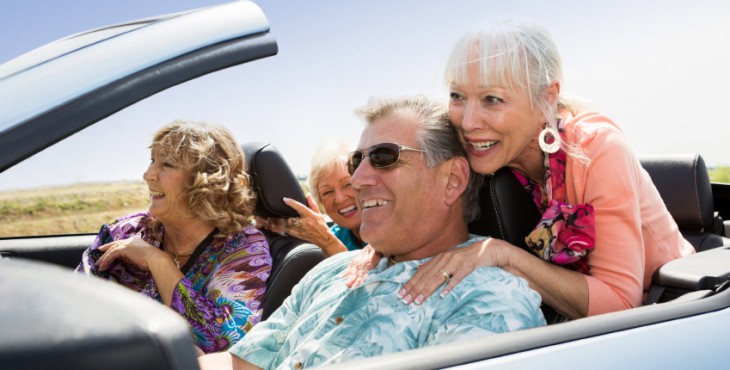 A group of seniors traveling in a converable.