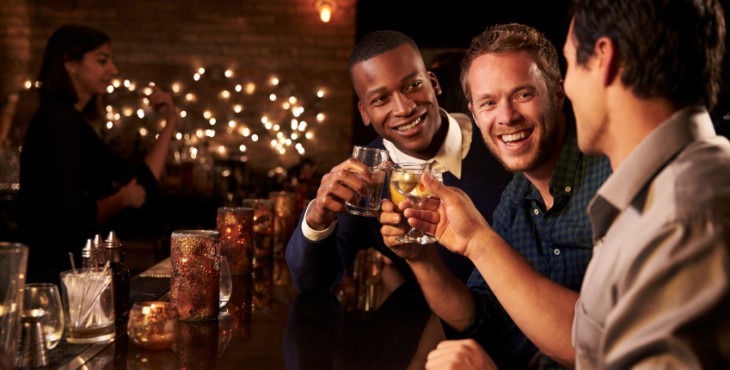 Male Friends Enjoying Night Out At Cocktail Bar