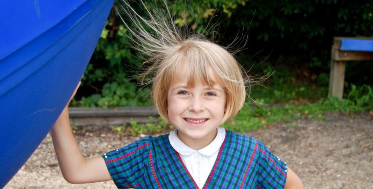 Smiling girl with static hair
