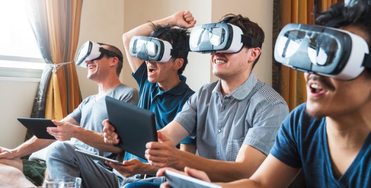 Group of friends playing games using virtual reality headsets